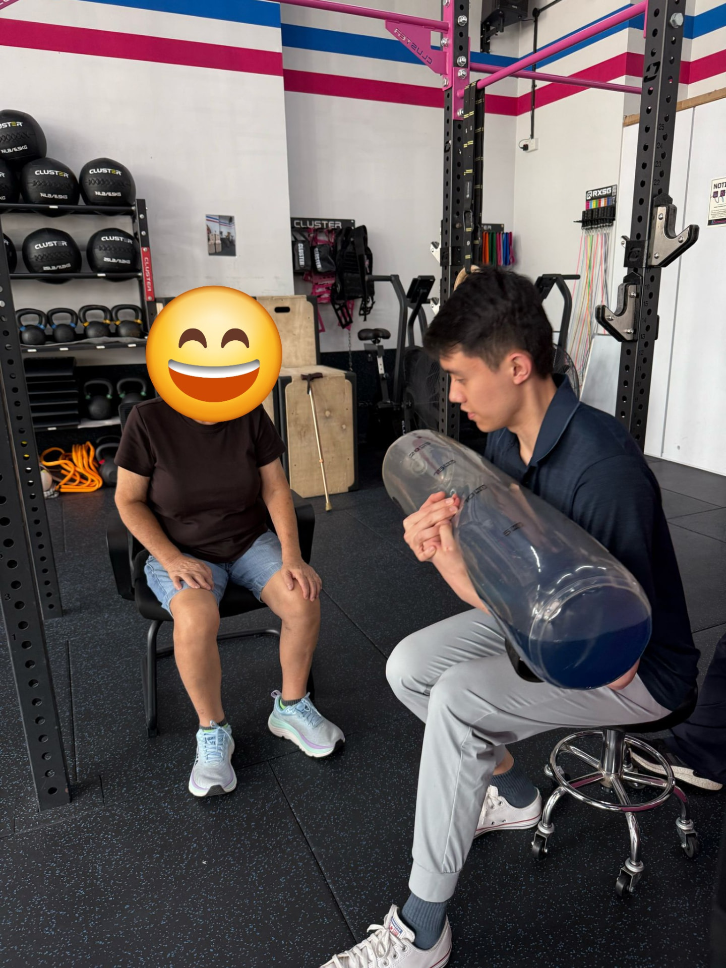 Donald demonstrating an aqua bag exercise to a patient